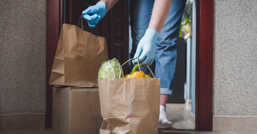 Image of delivery being made with protective gloves