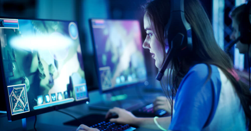 Photo of woman at computer playing video game