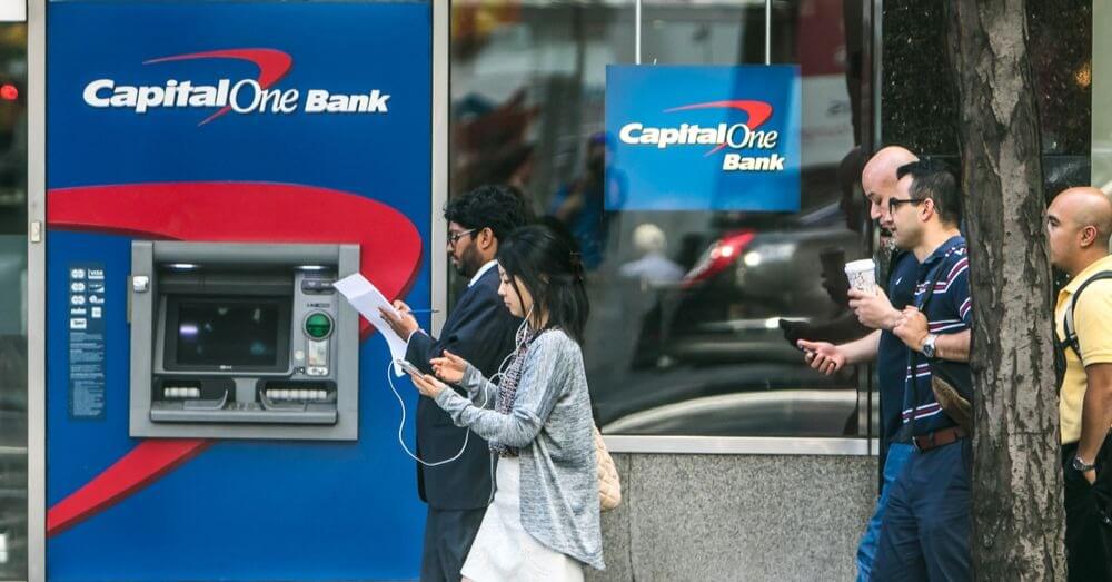 Image of a Capital One ATM with people walking in front