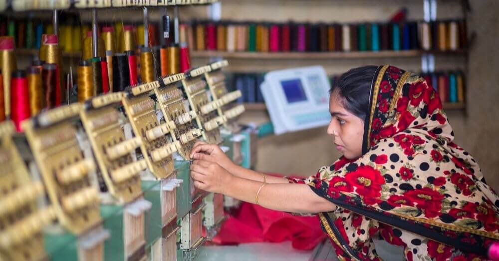 Image of woman using textile machine