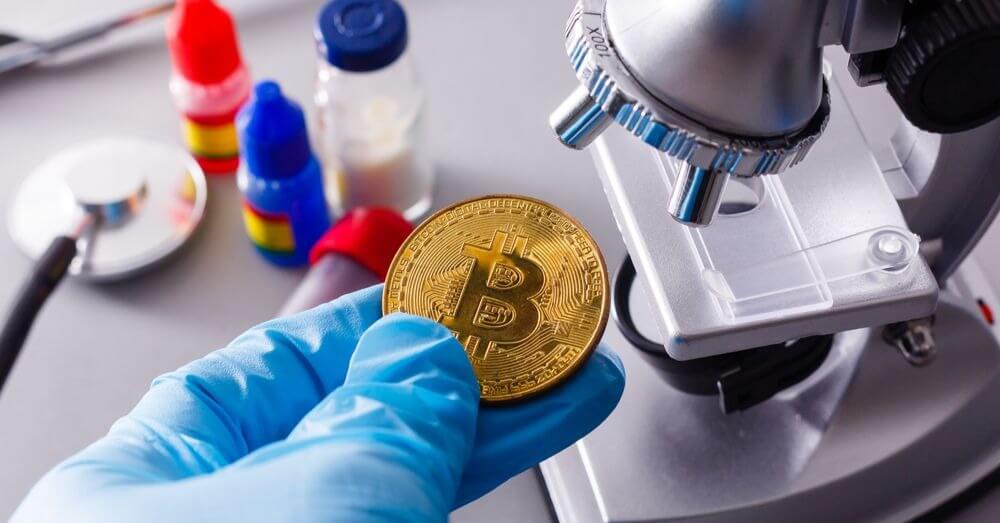 A bitcoin being put under a microscope