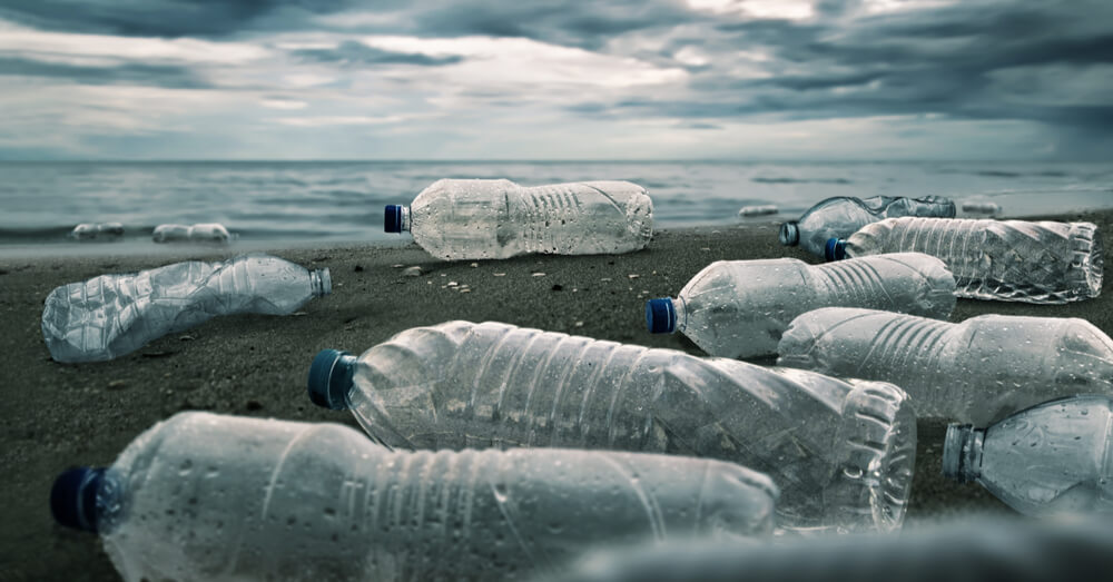 Image of discarded water bottles on the beach