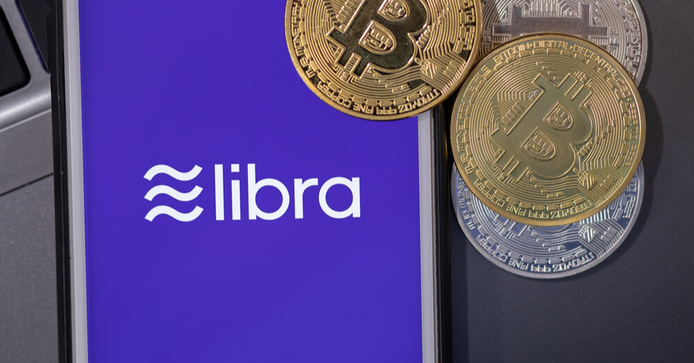 Bitcoins and smartphone screen showing the Libra logo