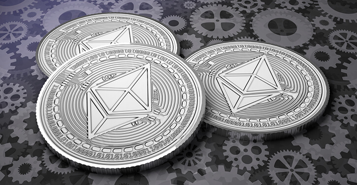 Thre Ethereum coins on gear floor background