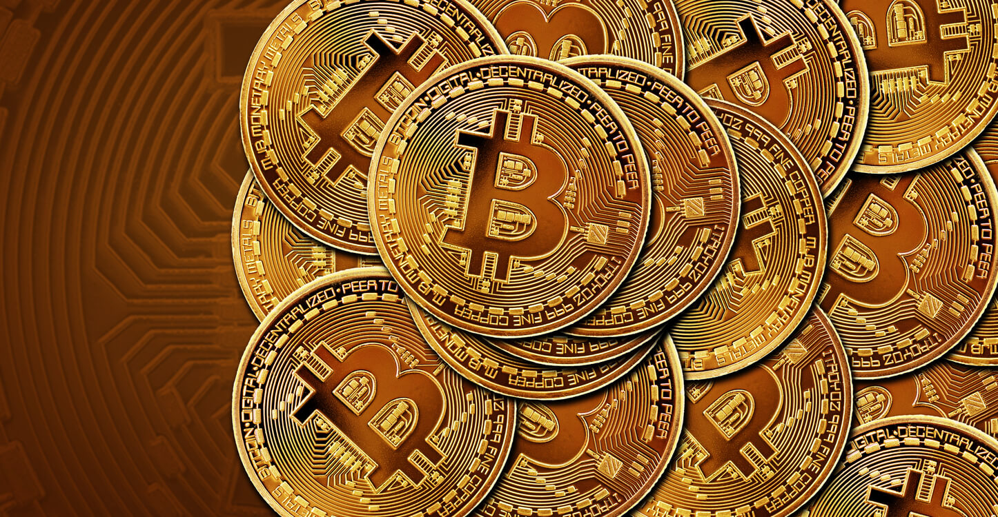 An image of BTC gold coins on a defocused background