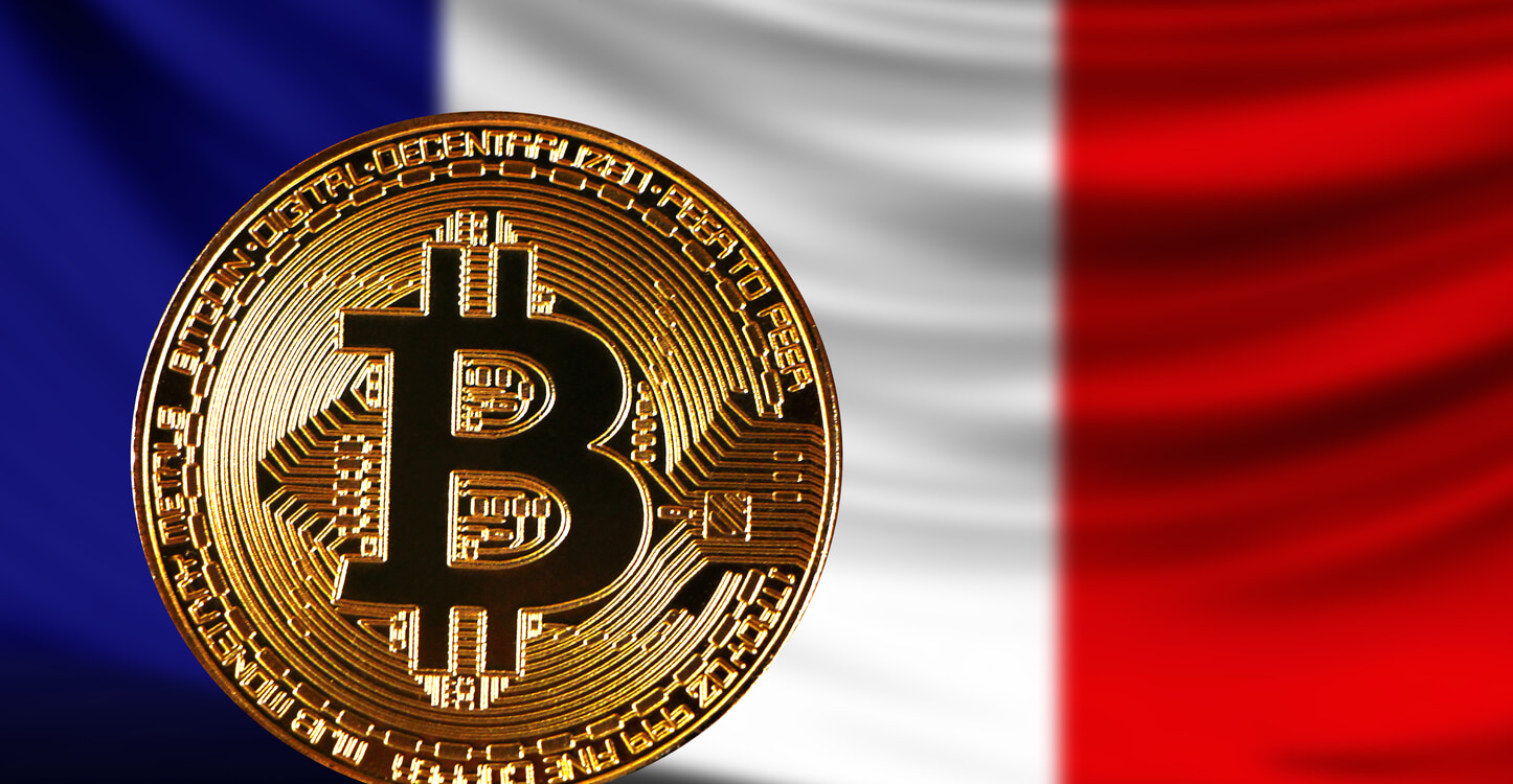 A gold Bitcoin on the background of a French flag