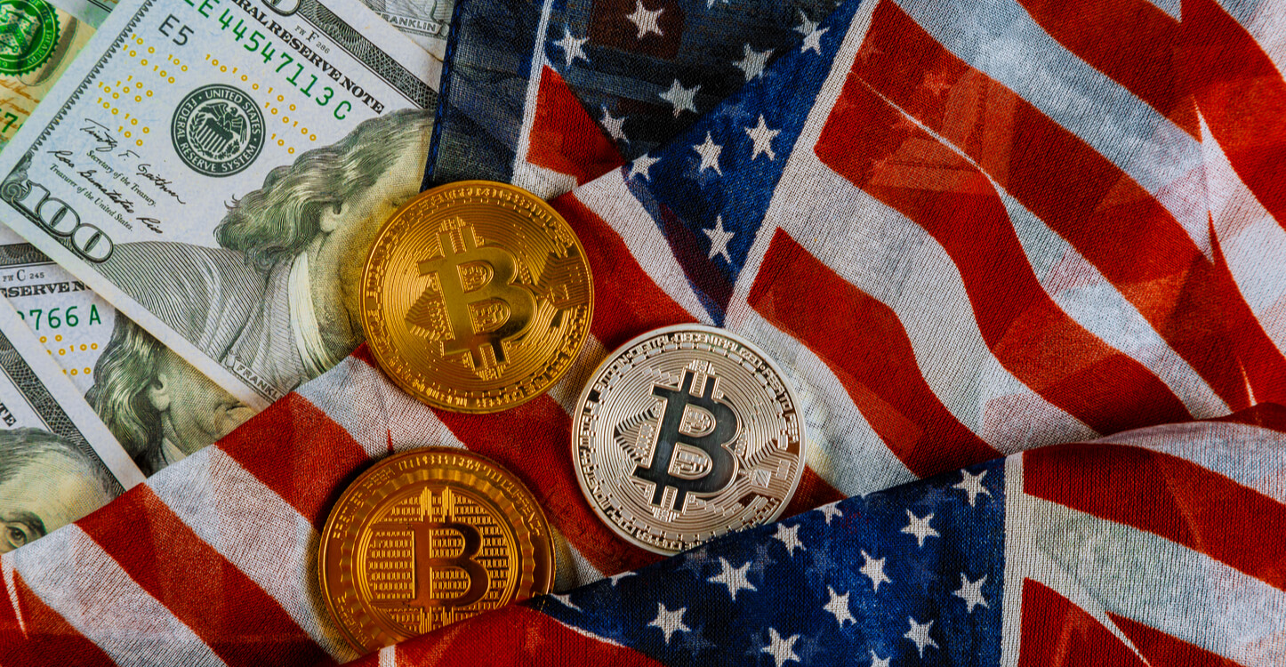 American flag on US dollars background and bitcoins