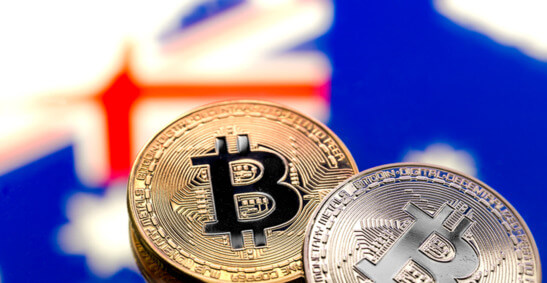 An image of bitcoins in front of the Australian flag