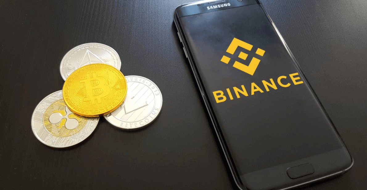 Binance-Logo auf Telefon mit Kryptowährungen