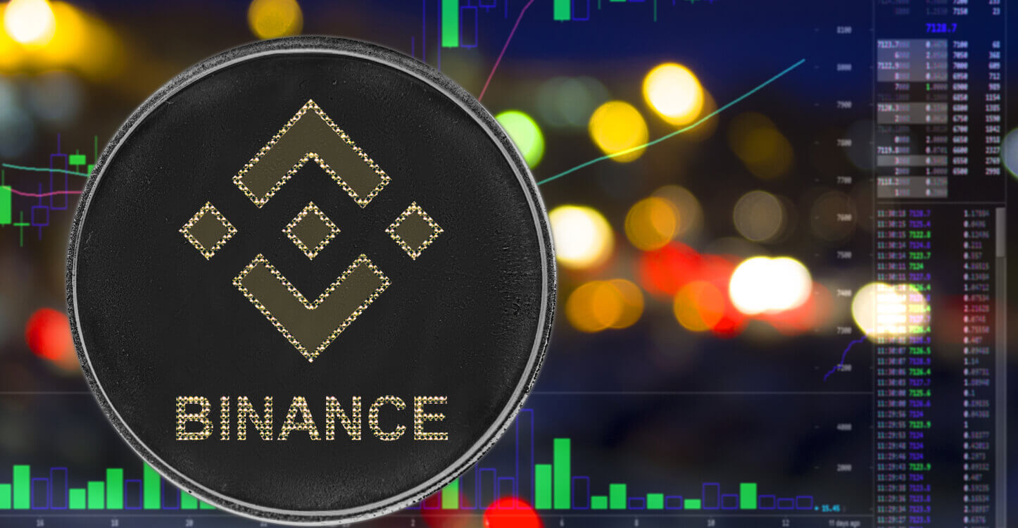 Une photo de Binance BNB avec un graphique haussier et des lumières de ville