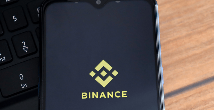 The Binance logo on a phone