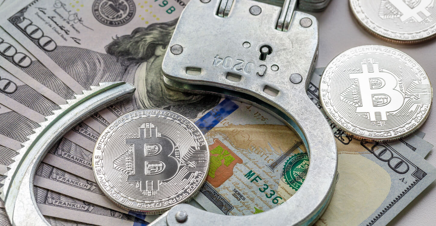 Bitcoin and handcuffs on banknotes