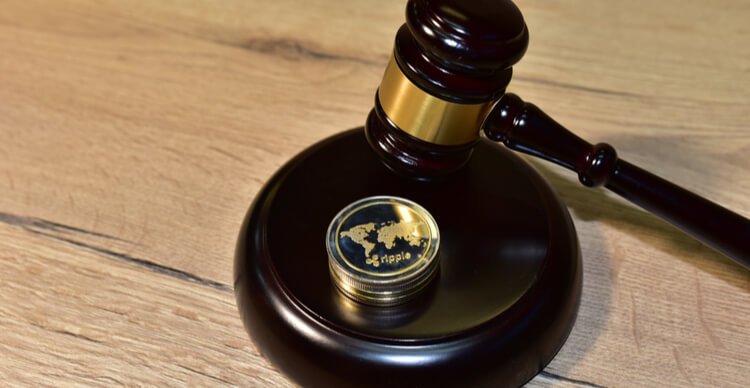 A judge’s gavel with an XRP coin