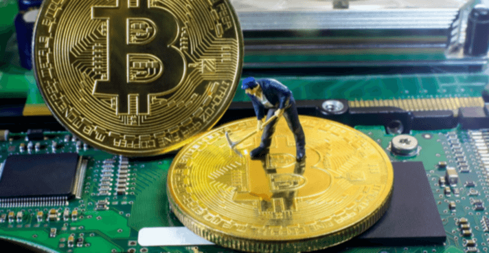 A little miner digging for Bitcoin on a graphic card