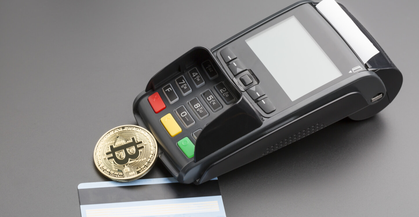 Image of a point of sale terminal, a credit card and Bitcoin