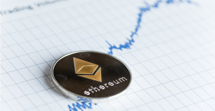 A virtual Ethereum logo levitating above a hand