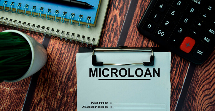 Concept image of a desk with a microloan clipboard