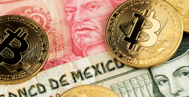 Close-up of bitcoins on top of Mexican pesos