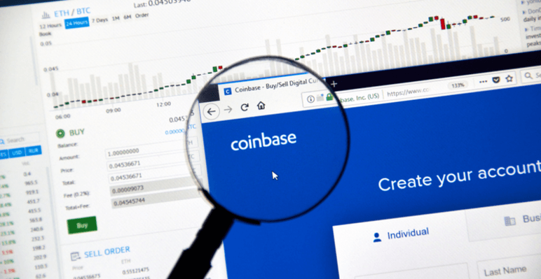 Image of Coinbase on a screen under a magnifying glass