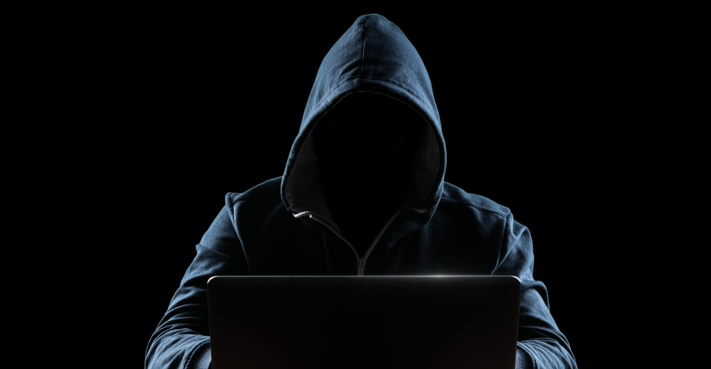 Image of faceless man using a laptop