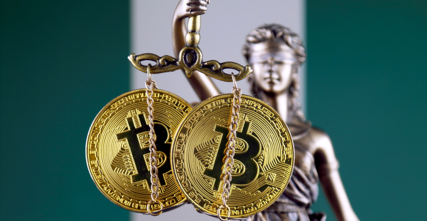 Image of Lady Justice holding Bitcoins in front of the Nigerian