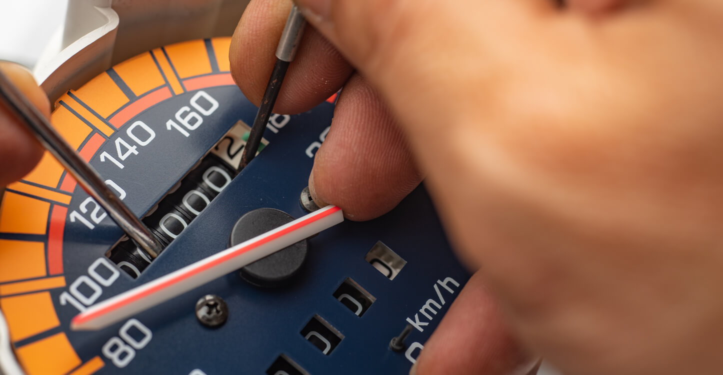 Image of someone changing an odometer