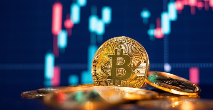 An image of bitcoins against a defocused chart background.