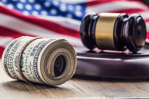US Senator asks DOJ to consider criminal charges against Binance and Tether &#8211; CoinJournal us flag with judges hammer and dollar bills